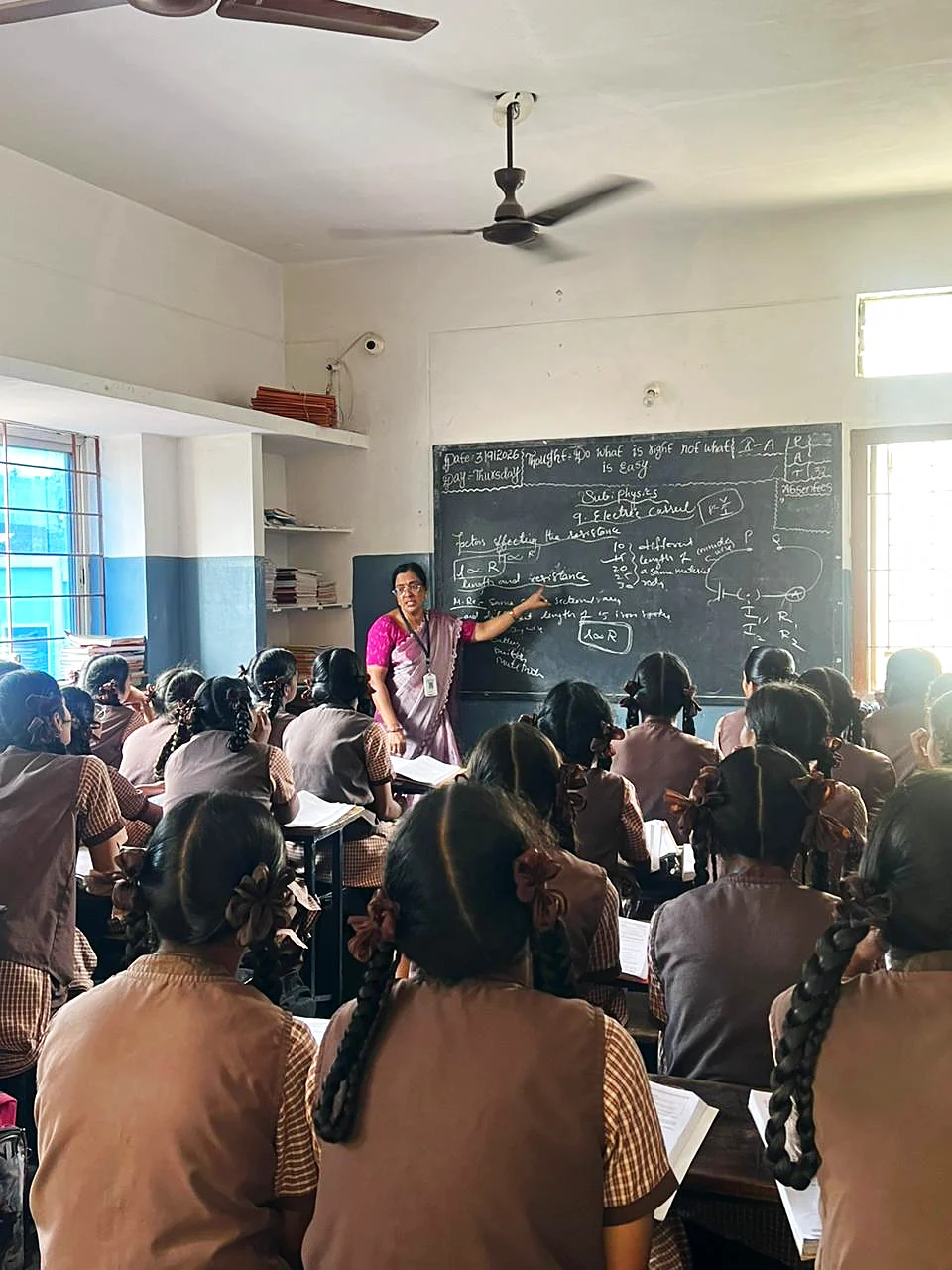 A teacher helping students during a lesson
